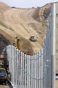 Posts were installed for fencing to run along the canyon on the Mexico border known as Smuggler's Gulch.