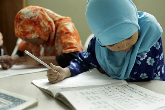 In a mosque fashioned from a condo unit in Santa Ana, Calif., Cham girls practiced writing the Arabic alphabet.