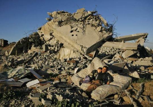 Palestinians yesterday amid the rubble of their house in the devastated area of east Jebaliya in the Gaza Strip.
