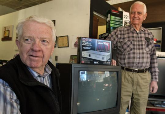 At Philip's TV in Brookline, owner Allen MacPherson (left) visits with Herb Pratt, who had to close his JP repair shop.