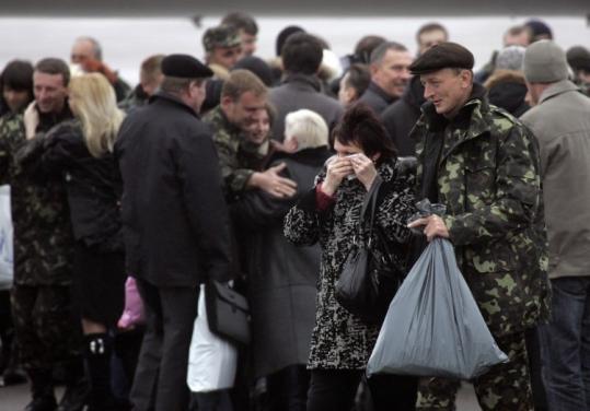 Crew members of the hijacked Ukrainian freighter MV Faina were welcomed by relatives at the Kiev airport yesterday.