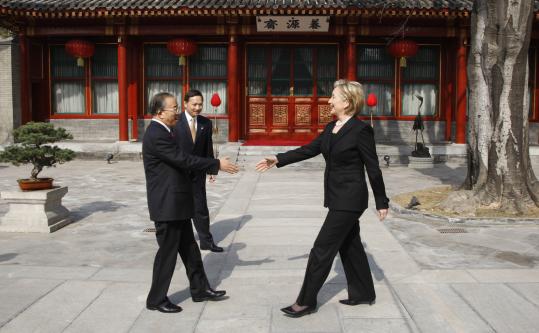 Secretary of State Hillary Clinton greeted Chinese State Councillor Dai Bingguo yesterday on the grounds of Beijing's Diaoyutai State Guesthouse. Clinton said that ''together we will help to lead the world recovery'' from the current economic crisis.
