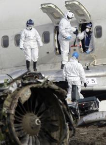 Forensic experts yesterday examined the wreckage of a Turkish Airlines jet near Amsterdam's Schiphol Airport. The jet crashed into a field on Wednesday, killing nine of 135 people on board.