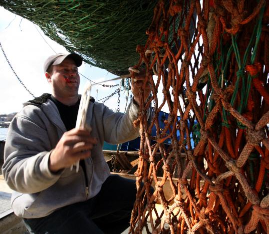 Fishing boat captain Dustin Ketchopulos (above, in Rockport) is interested in a CSF that would sell shrimp.