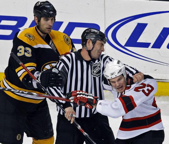 Zdeno Chara (left) showed he wasn't afraid of rough stuff against the Devils, as David Clarkson (right) could attest.
