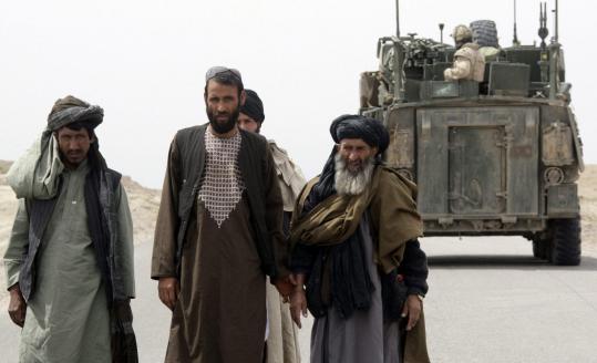 A group of Afghans in Kandahar waited as Canadian soldiers from a NATO-led coalition checked their car.