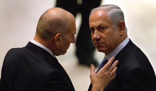 Benjamin Netanyahu conferred with outgoing prime minister Ehud Olmert, before yesterday's swearing-in ceremony in Jerusalem.