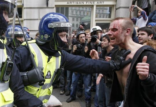 ANDREW WINNING/REUTERSDemonstrators clashed with riot police and smashed bank windows in London's financial district yesterday in protest against a system they said had robbed the poor to benefit the rich.