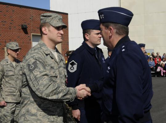 Michael Akey (right), commander of the Massachusetts Air National Guard, presented a Bronze Star for Valor to Technical Sergeant Gregory Pauli.