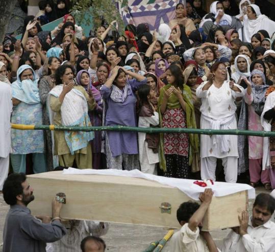 Pakistani Shi'ite Muslims mourned their relatives yesterday as coffins were carried during a funeral ceremony for victims of Sunday's suicide bomb blast in Chakwal, south of Islamabad.