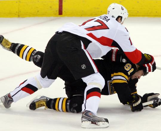 Marc Savard, who had two assists, could have used some help as he got decked by the Senators' Filip Kuba.