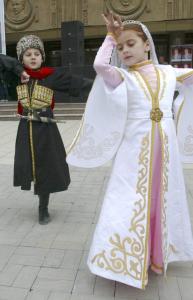 Chechen children dressed in national costumes danced in Grozny yesterday during celebrations of the lifting of the security regime. The republic could allow international flights soon.