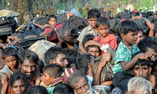 reutersCivilians arrived at a safe Sri Lanka village yesterday after fleeing an area held by rebel forces that was breached by the army.