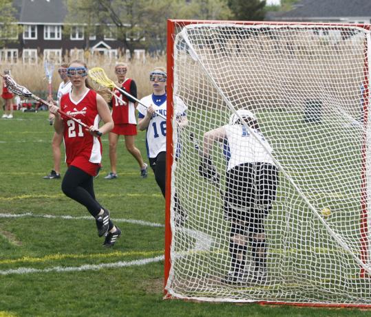 (Above), Hingham's Shannon Delaney (21) watches her shot get by Quincy's Vanessa Hodgdon (14) at Monday's game. (Left), Hingham's Mary Kate Gorman (6) gets by Quincy's Sarah Ahola (13).