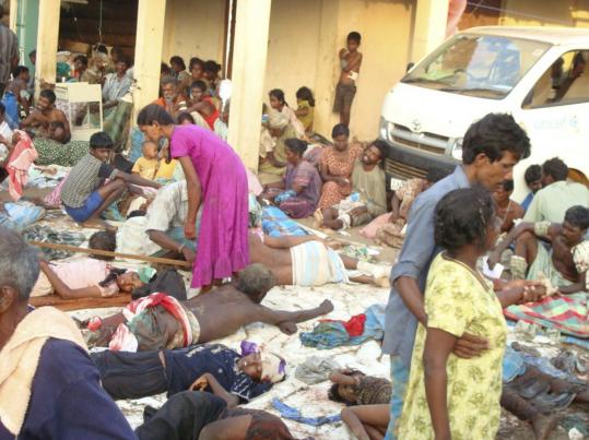 Victims of an artillery attack in a Tamil section of Sri Lanka waited outside a makeshift hospital in Mullivaaykaal yesterday.