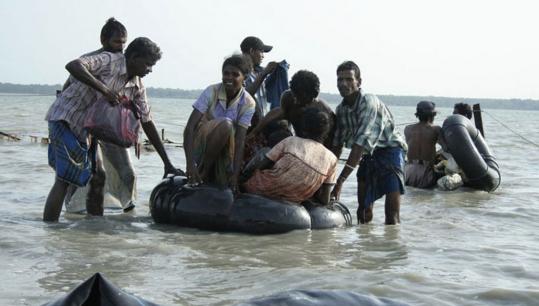 Internally displaced ethnic Tamil civilians crossed a lagoon this week to reach government controlled areas in Vellamullivaikal, Sri Lanka. A senior UN envoy arrived in the country yesterday to try to persuade the government to agree to a cease-fire.