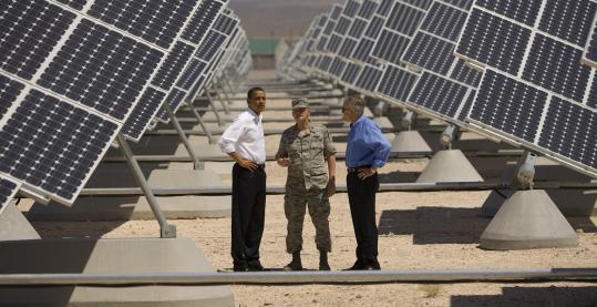 JOHN LOCHER/GETTY IMAGES President Obama at a Las Vegas solar power site yesterday with Colonel Howard Belote and Senate Majority Leader Harry Reid.