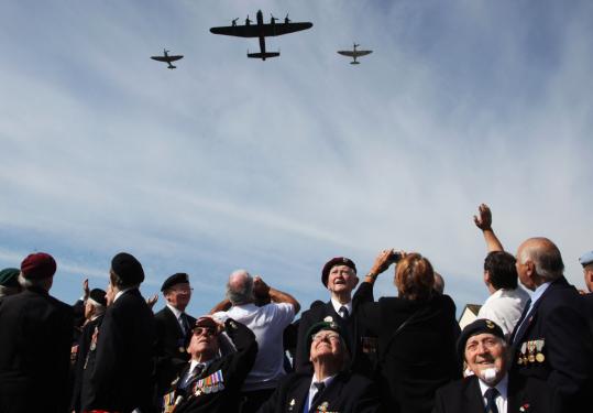 Normandy veterans watched yesterday as the D-day memorial flight passed during a ceremony near what was the British Sword beach at Colleville Montgomery near Caen, France.