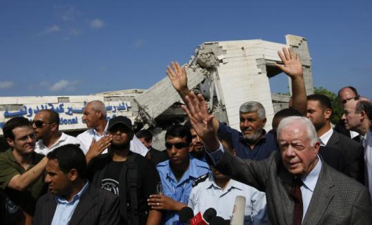 Former president Jimmy Carter arrived yesterday at the site of the destroyed American International School in Gaza.