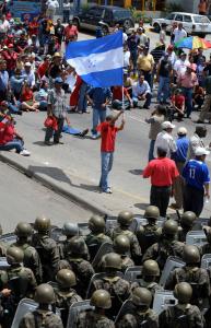 Supporters of the ousted president of Honduras, Manuel Zelaya, sat yesterday to avoid being removed by soldiers, in streets surrounding Tegucigalpa’s international airport.
