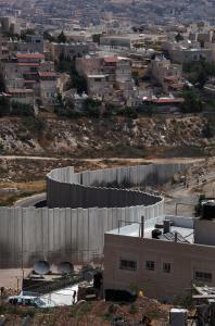 Israel’s controversial West Bank barrier divides the Palestinian refugee camp of Shuafat (foreground) and the Jewish neighborhood of Pisgat Zeev in East Jerusalem.