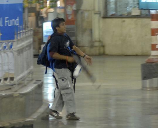 An armed man identified as Ajmal Kasab walked through the railway station in Mumbai in November. He is the lone surviving gunman in the rampage, which killed 166 people.