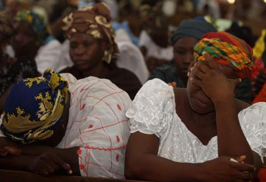 Women pray at St. Patrick’s Cathedral in Maiduguri yesterday, after violence in the city between government police and members of a radical Islamist group left several hundred people dead.