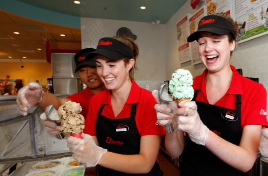 Brian Schweikert trained Rebecca Levine (center) and Megan Campbell in scooping ice cream at the Friendly’s Express that will open tomorrow in Mansfield. (Barry Chin/ Globe Staff) 