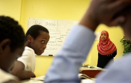 Ardo Mohamed (right) quizzed students, including Burhan Ali (left), on Somali vocabulary words during a recent class. Some of the students are taking the six-week course to better communicate with their parents.