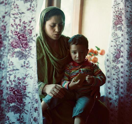 A sister of murder victim Nilofa Jan tended to Jan’s 2-year-old son, Suzain, in Kashmir, India.