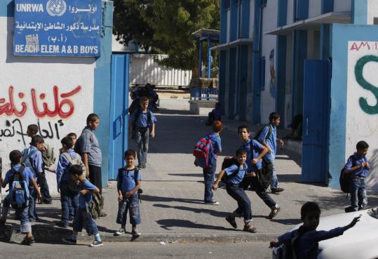 Palestinian gathered outside a United Nations school in Gaza City yesterday. A senior Hamas official criticized plans by the United Nations to teach Gaza students about the Nazi genocide.