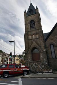 The SUV carrying a Boston fire chief from District 9 crashed into a stone wall at St. Andrew’s Church in Jamaica Plain yesterday after getting hit by another vehicle as it responded to a call.