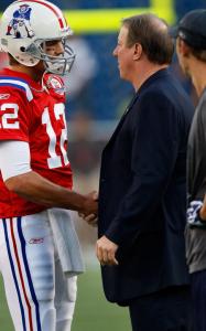 Patriots quarterback Tom Brady is greeted by Bills Hall of Famer Jim Kelly during pregame warmups.