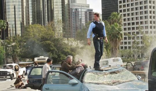 Joseph Fiennes (on car) is FBI agent and family man Mark Benford in the new ABC drama “FlashForward.’’