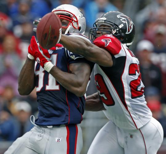 Falcon defender Brian Williams strong-armed Randy Moss on this pass, one of the few times Atlanta was able to stop the Patriots star receiver.