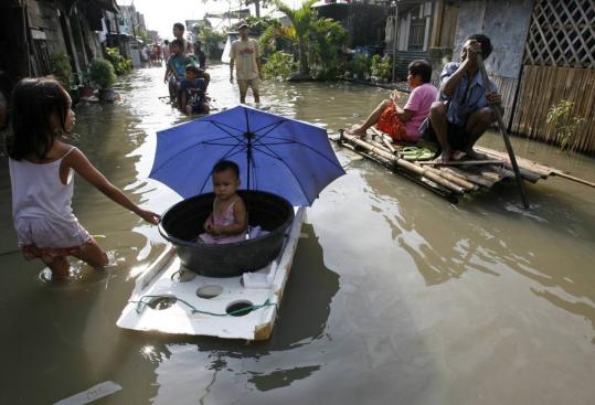 Residents waded through flood waters in Taytay Rizal, east of Manila, after Typhoon Ketsana pummeled the Philippines, Cambodia, and Vietnam. The Philippines death toll was 246.