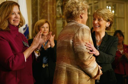 Attorney General Martha Coakley, right, greeted Ellen R. Malcolm, founder of EMILY’s List, with other supporters last night at a campaign event in Boston.
