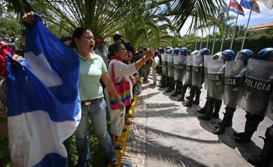 Supporters of ousted Honduran president Manuel Zelaya demonstrated outside the hotel where agents representing Zelaya and the interim government met with diplomats in Tegucigalpa.