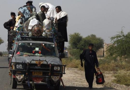 Residents fleeing an offensive against the Pakistani Taliban entered Dera Ismail Khan from South Waziristan yesterday.