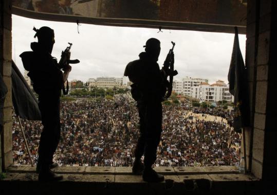 Palestinian militants stood guard during a rally in Gaza City on Friday. Secretary of State Hillary Rodham Clinton’s position was clearly at odds with the prevailing Palestinian view.