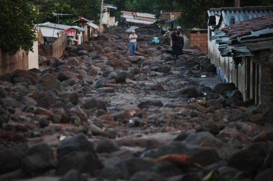 Boulders, many weighing more than a ton, littered the cobblestone streets of Verapaz, El Salvador, yesterday. The farming town was hit hard by the landslides.