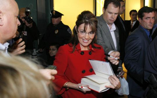 GOP CELEBRITY AND HER BESTSELLER - Sarah Palin autographed her new book, “Going Rogue,’’ for a customer yesterday in Grand Rapids, Mich. More than 1,000 people waited in line on the first stop of her book tour.
