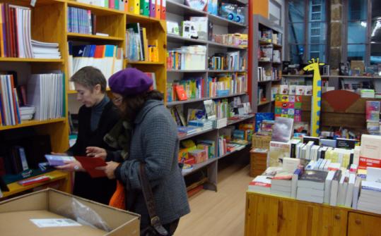 Corinne Dalloz assisted a customer in a bookstore in Poligny, France. Residents banded together to keep it from closing.