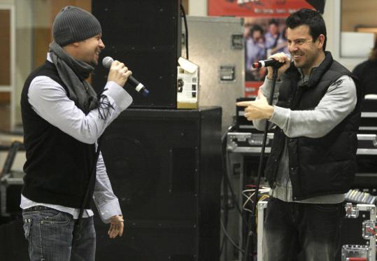Donnie Wahlberg (left) and Jordan Knight of New Kids on the Block practice last night in Ernie Boch’s hangar at Norwood Airport.