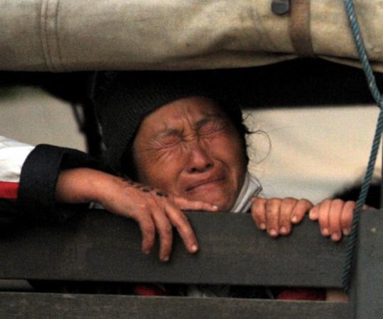 An emotional refugee waited inside a Thai police truck during the operation to deport thousands of Hmong to Laos.