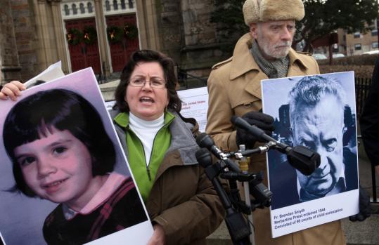 Helen McGonigle held a photo of herself as a child around the time she was abused by a priest named Brendan Smyth in East Greenwich, R.I. Stephen Sheehan held the photo of her abuser.