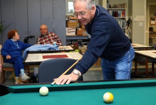 Arthur Lowell, 80, played pool recently at the Hopkinton Senior Center. Lowell pulled his investment income out of CDs when rates began to decline and moved about $60,000 into the stock market. “We all know how that went,’’ he said.