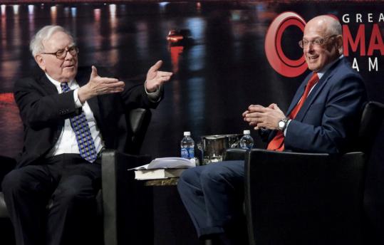 Billionaire Warren Buffett (left) and former US Treasury Secretary Henry Paulson talked about the economy yesterday on stage at the Greater Omaha Chamber of Commerce’s annual meeting.