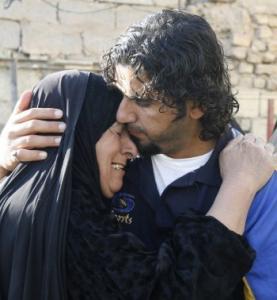 Photographer Ibrahim Jassam embraced his mother after he was released.