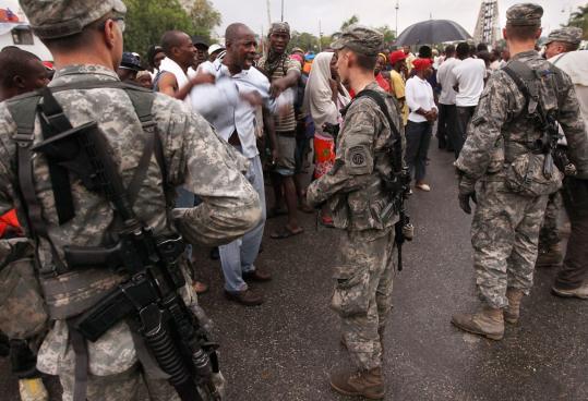 A frustrated Haitian shouted at a US soldier yesterday as protesters demanded more food aid in Port-au-Prince, about a month after a devastating earthquake rocked the Caribbean nation.